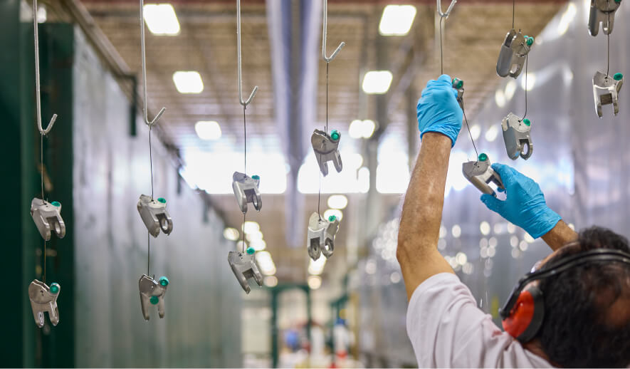 factory worker hanging up chair components